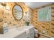Stylish powder room with unique wallpaper, a round mirror, and modern fixtures at 3609 Meadow Chase Dr, Marietta, GA 30062