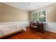 Cozy bedroom with hardwood floors, classic desk and chair, and window with shutters at 3609 Meadow Chase Dr, Marietta, GA 30062