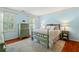 Serene bedroom featuring hardwood floors, blue walls, and vintage furnishings at 3609 Meadow Chase Dr, Marietta, GA 30062