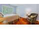 Tranquil bedroom with hardwood floors, natural light, and a cozy chair at 3609 Meadow Chase Dr, Marietta, GA 30062