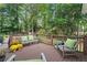 Relaxing wooden deck with seating, colorful flowers, and views of the tree-filled backyard at 3609 Meadow Chase Dr, Marietta, GA 30062