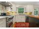 Bright kitchen featuring stainless steel appliances, white cabinetry, and a decorative tile backsplash at 3609 Meadow Chase Dr, Marietta, GA 30062
