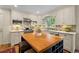 Well-lit kitchen features white cabinets, an island with wine storage, and stainless steel appliances at 3609 Meadow Chase Dr, Marietta, GA 30062