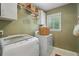 Practical laundry room equipped with modern washer, dryer and storage at 3609 Meadow Chase Dr, Marietta, GA 30062