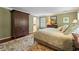 Comfortable bedroom featuring neutral walls, a large armoire, and an ensuite bathroom at 3609 Meadow Chase Dr, Marietta, GA 30062