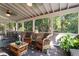 Screened porch offering comfortable seating, decorative accents, and views of the lush outdoor scenery at 3609 Meadow Chase Dr, Marietta, GA 30062