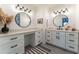 Bright bathroom featuring dual sinks, modern fixtures, and ample storage with white cabinetry and sleek black hardware at 361 Princeton Way, Lawrenceville, GA 30044