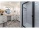 Bathroom showcasing the vanity with dual sinks, black hardware, and a walk-in shower with subway tile and black hardware at 361 Princeton Way, Lawrenceville, GA 30044