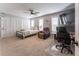 Spacious bedroom with a bed, office space, sitting area, and a ceiling fan offering comfort and functionality at 361 Princeton Way, Lawrenceville, GA 30044