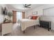 Cozy bedroom featuring light colored walls, ceiling fan, and sliding barn doors at 361 Princeton Way, Lawrenceville, GA 30044