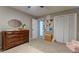 Cozy Bedroom featuring a dresser, a mirror, decor, and shelving; creates an organized and playful space for children at 361 Princeton Way, Lawrenceville, GA 30044