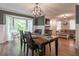 Dining room with a dark wood table and bay window, opening up to the living room at 361 Princeton Way, Lawrenceville, GA 30044