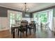 Dining room featuring a dark table, bay window and backyard view at 361 Princeton Way, Lawrenceville, GA 30044