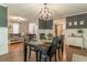 Dining room with dark table, opening to a living room and an updated kitchen at 361 Princeton Way, Lawrenceville, GA 30044
