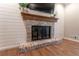 Brick fireplace with rustic mantel and brick hearth, perfect for cozy evenings in this living room at 361 Princeton Way, Lawrenceville, GA 30044