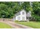 Gray two-story home with attached garage, basketball court, lush landscaping, and covered front porch at 361 Princeton Way, Lawrenceville, GA 30044