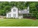 Charming two-story home features a covered porch, green door, basketball court, and lush front yard at 361 Princeton Way, Lawrenceville, GA 30044