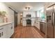 Updated kitchen with stainless appliances, granite counters, white cabinets and a sliding barn door at 361 Princeton Way, Lawrenceville, GA 30044