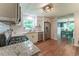Renovated kitchen features stainless appliances, white cabinets and views of dining room at 361 Princeton Way, Lawrenceville, GA 30044