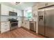 Renovated kitchen with stainless appliances, granite counters, white cabinets and subway tile backsplash at 361 Princeton Way, Lawrenceville, GA 30044