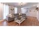 Living room with wood floors, large sofa, fireplace, and lots of light from the windows at 361 Princeton Way, Lawrenceville, GA 30044