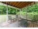 Inviting screened porch with a wood ceiling, outdoor furniture, and tranquil views of the green backyard at 361 Princeton Way, Lawrenceville, GA 30044