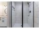 Updated walk-in shower featuring white subway tile, black hardware, and a glass door for a modern and stylish look at 361 Princeton Way, Lawrenceville, GA 30044