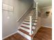 Staircase features wood treads, white risers, and a contemporary black metal railing at 361 Princeton Way, Lawrenceville, GA 30044
