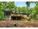 Back of home featuring a large deck, screened in porch, and lush green surroundings at 3992 Joshua Ln, Douglasville, GA 30135