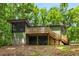 Back of home featuring a large deck, screened in porch, and lush green surroundings at 3992 Joshua Ln, Douglasville, GA 30135