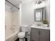 Bathroom showcasing a gray vanity, tub with shower, and stylish lighting fixtures at 3992 Joshua Ln, Douglasville, GA 30135