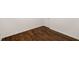 Angle of a bedroom showcasing dark wood floors and white baseboards at 3992 Joshua Ln, Douglasville, GA 30135