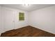 Cozy bedroom featuring hardwood floors, neutral paint, and a bright window at 3992 Joshua Ln, Douglasville, GA 30135