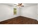 Cozy bedroom featuring gleaming hardwood floors, a window, and neutral paint at 3992 Joshua Ln, Douglasville, GA 30135
