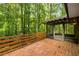Spacious wooden deck with a screened-in porch for outdoor relaxation and wooded views at 3992 Joshua Ln, Douglasville, GA 30135
