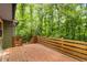 Expansive wooden deck surrounded by lush greenery and mature trees, perfect for outdoor enjoyment at 3992 Joshua Ln, Douglasville, GA 30135