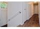 Hallway featuring wood flooring and white doors, with a view of the home's entrance at 3992 Joshua Ln, Douglasville, GA 30135