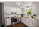 Bright kitchen features white cabinets, stainless appliances and granite countertops at 3992 Joshua Ln, Douglasville, GA 30135