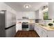 Well-lit kitchen featuring white cabinets, stainless steel appliances, and modern fixtures at 3992 Joshua Ln, Douglasville, GA 30135