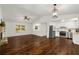 Open-concept living room featuring hardwood floors, fireplace, and kitchen with stainless steel appliances at 3992 Joshua Ln, Douglasville, GA 30135