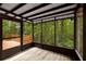 View of the screened porch surrounded by wooded area at 3992 Joshua Ln, Douglasville, GA 30135