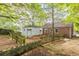 View of the home's fenced backyard with a small brick house and shed at 879 Sylvan Sw Pl, Atlanta, GA 30310
