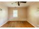 Bedroom with a ceiling fan, a window providing natural light, and hardwood floors at 879 Sylvan Sw Pl, Atlanta, GA 30310