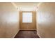 Small room with neutral walls, carpet, and a window with blinds at 879 Sylvan Sw Pl, Atlanta, GA 30310
