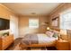 Bedroom decorated with a queen bed, side tables, and wood paneled walls at 879 Sylvan Sw Pl, Atlanta, GA 30310