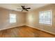 Spacious bedroom featuring natural light, wood floors and a ceiling fan at 879 Sylvan Sw Pl, Atlanta, GA 30310