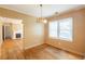 Bright dining room featuring hardwood floors and a classic chandelier at 879 Sylvan Sw Pl, Atlanta, GA 30310