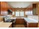 Well-equipped kitchen featuring wood cabinets, stainless steel sink, and efficient appliances at 879 Sylvan Sw Pl, Atlanta, GA 30310
