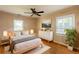 Bright, stylish bedroom with wood floors, ceiling fan, and a decorative plant at 879 Sylvan Sw Pl, Atlanta, GA 30310