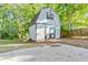 Charming barn with grey siding, diamond patterned door, and loft window adds character to this property at 733 Wesley Chapel Rd, Villa Rica, GA 30180